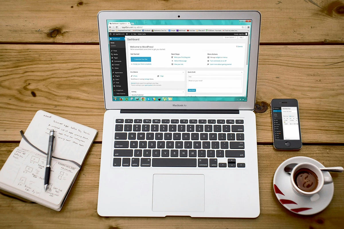 Laptop, book, and coffee at desk