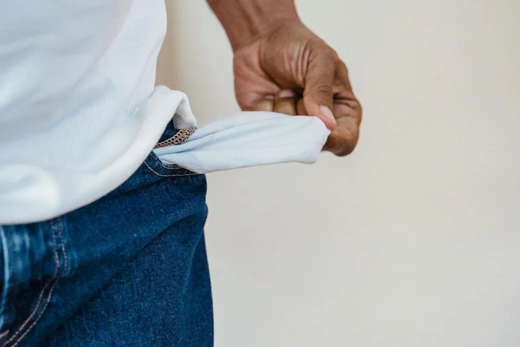 man showing empty pocket jeans