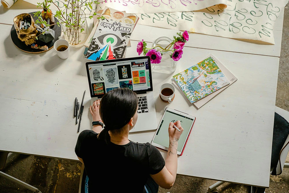 Woman working on a laptop and tablet